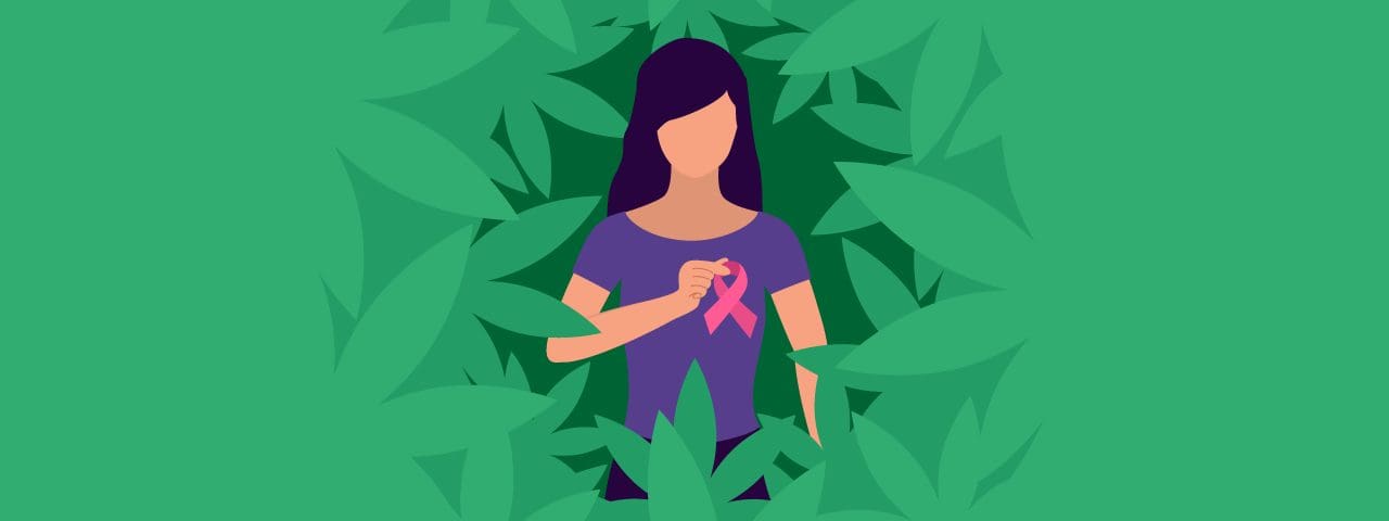 A woman surrounded by greenery holding a pink ribbon to her breast