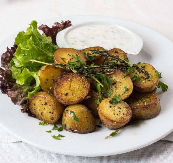 Baked, roasted potatoes with garlic sauce.
