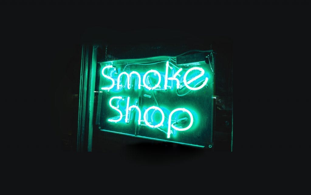 Reading a dispensary menu - smoke shop and medical marijuana dispensary neon sign