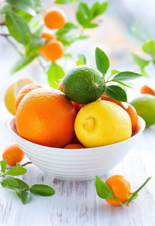 mixed citrus fruits in a white bowl