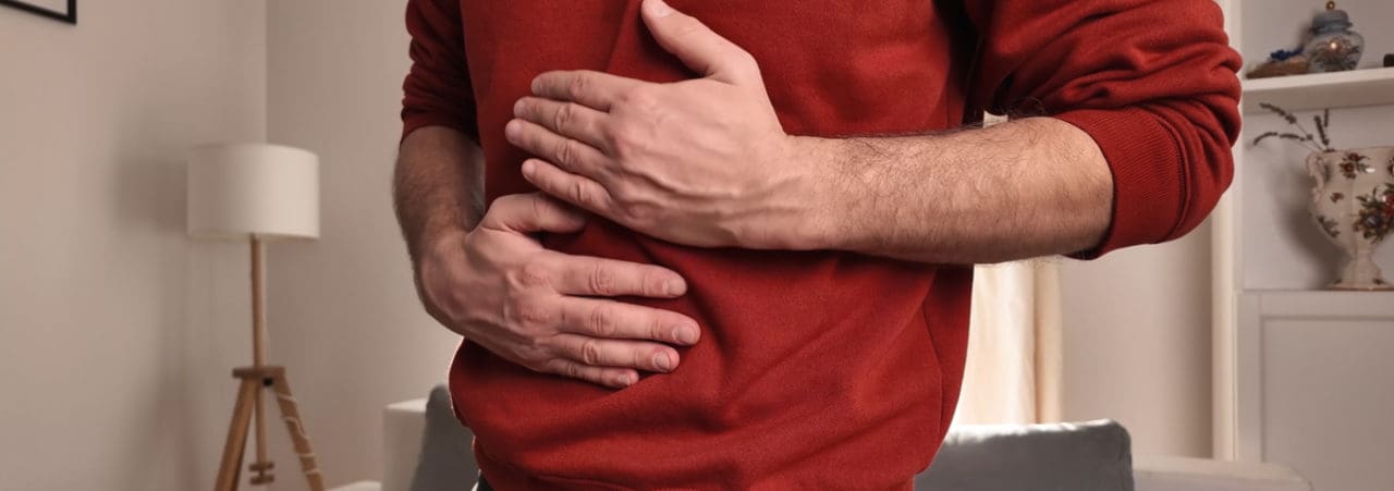 Man with chest and abdominal pain at home.