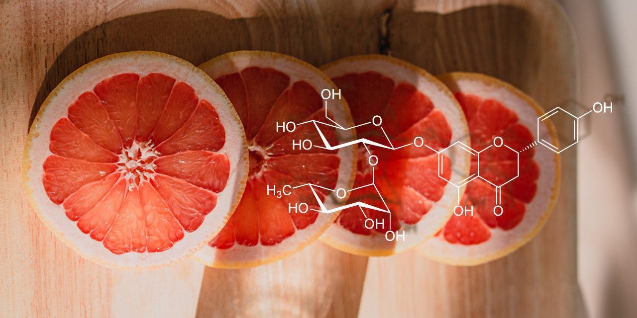 Structure of the chemical compound naringin with grapefruit slices in the background