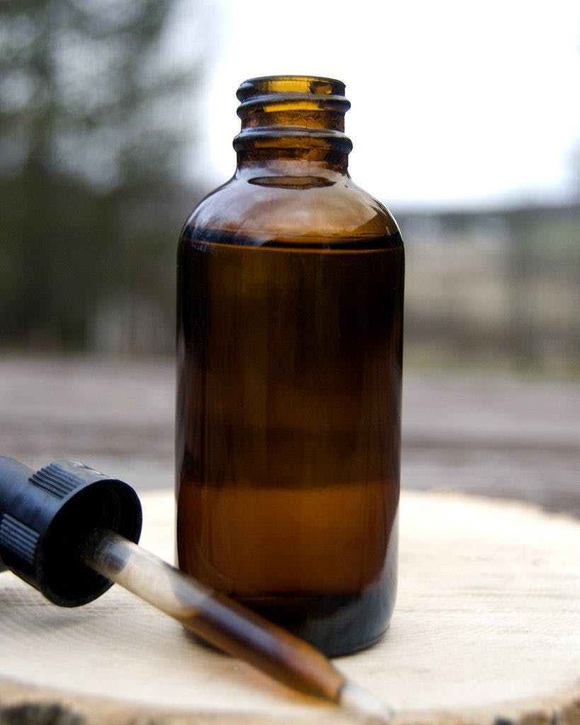 Homemade cannabis tincture in a brown bottle.