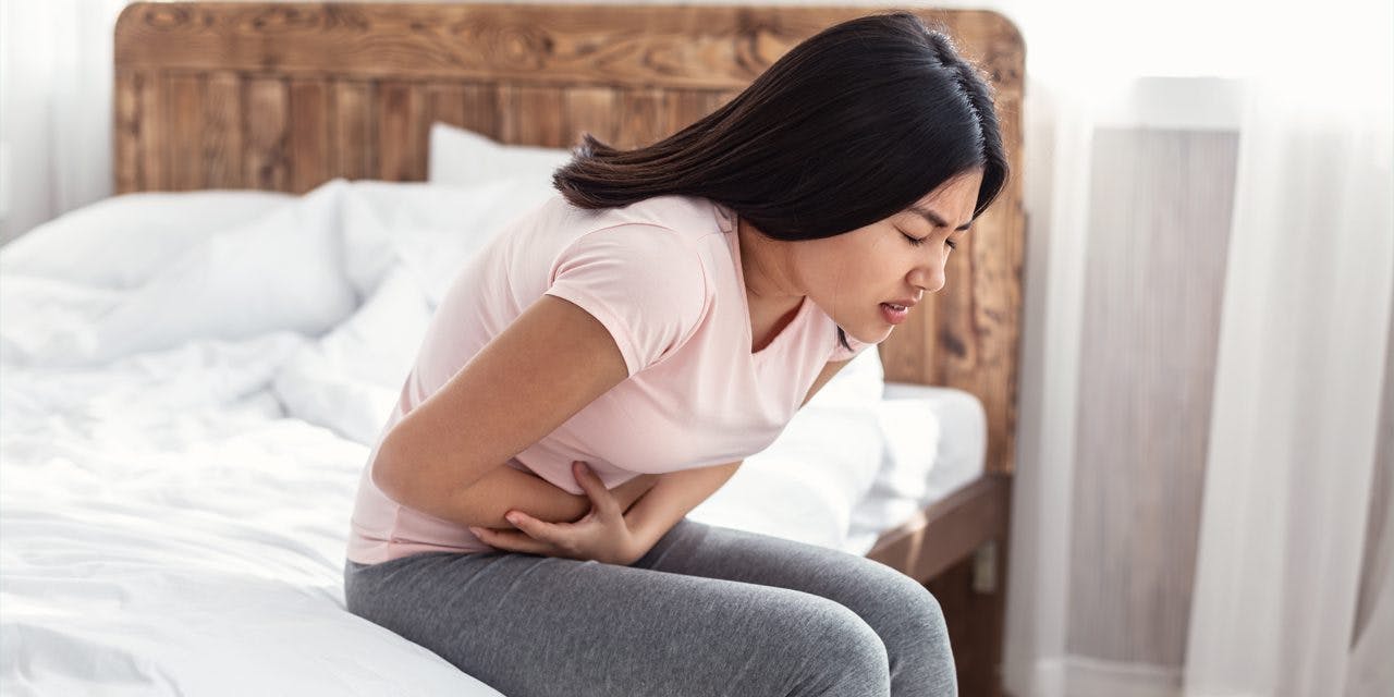 young woman suffering from stomach pain