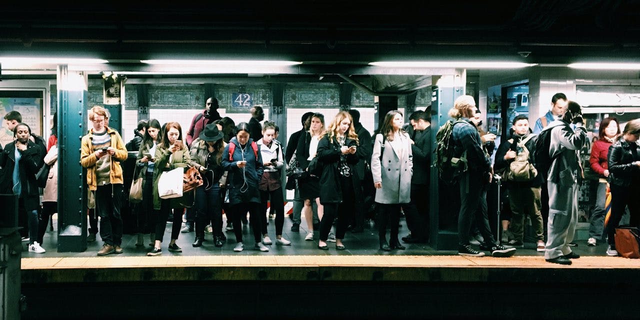 people waiting for train on subway