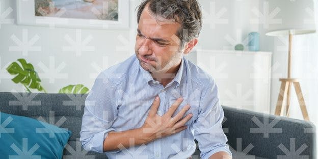 a man holding his chest and in pain