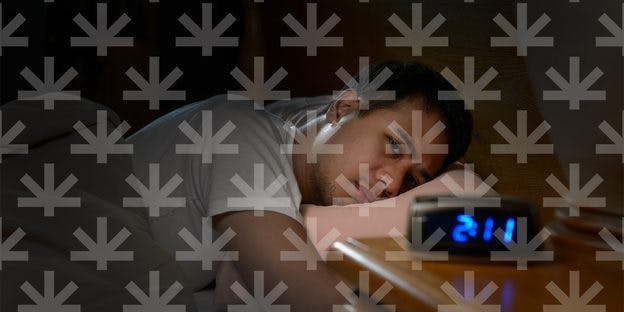 man lying on the bed facing the digital clock