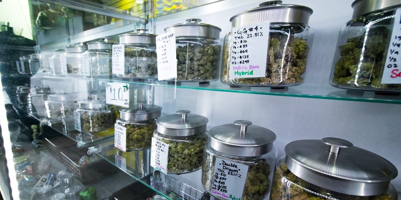 a pantry of different marijuana strains in air tight jars