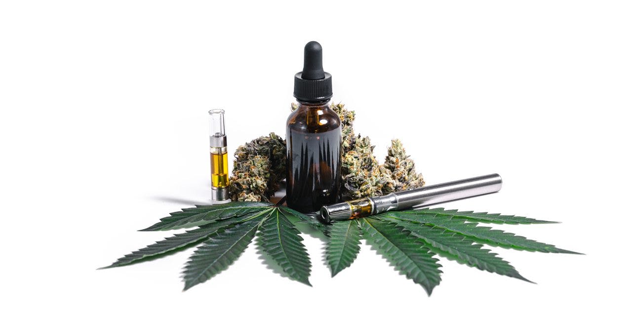 cbd oil with weed, different pens and marijuana leaf around it