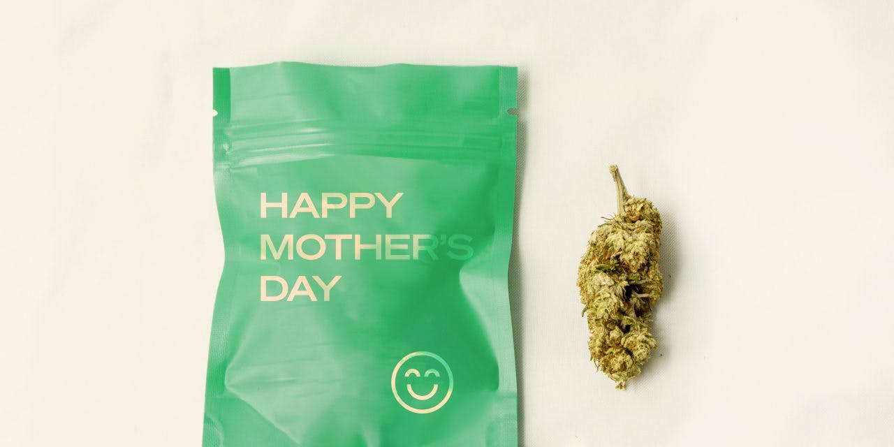 a green pouch written with Happy Mother's Day beside a dried cannabis
