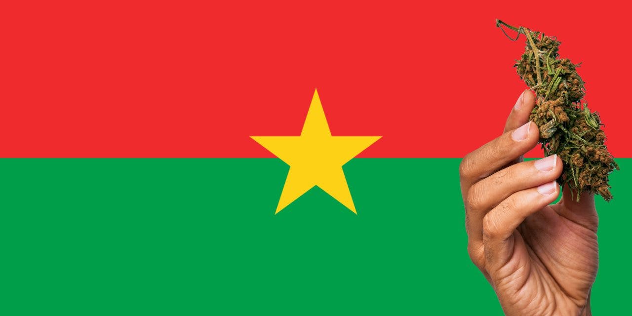Burkina Faso flag with a hand holding a marijuana infront of it