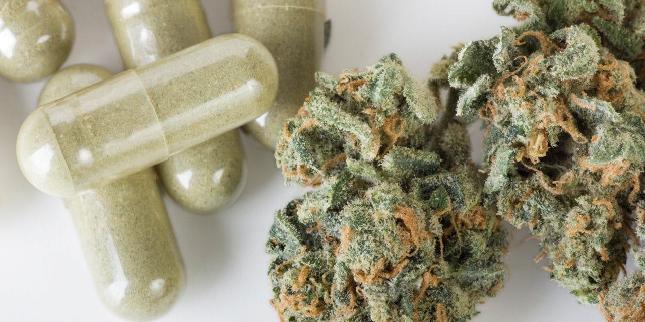 capsules beside cannabis chunks