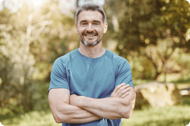 veteran standing and smiling outdoors